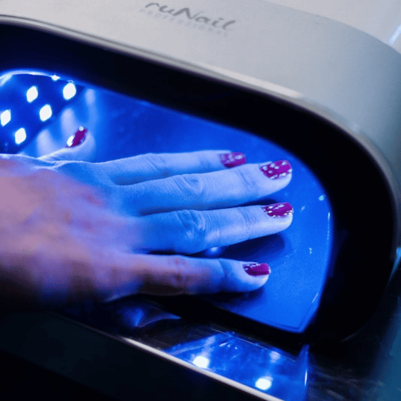 A lady's hand under a UV Lamp